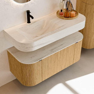 MONDIAZ THOR-DLUX 110cm badmeubel ronding links + rechts kleur Oak met 1 lade en 2 deuren. Vrijhangende wastafel CLOUD Links 1 kraangat kleur Meli.