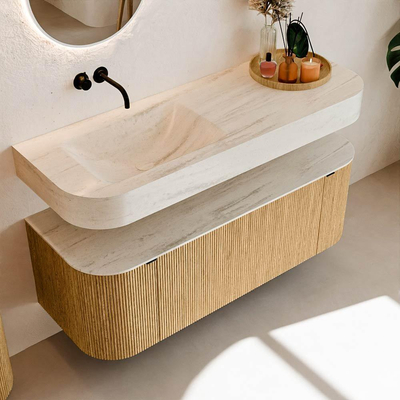 MONDIAZ THOR-DLUX 130cm badmeubel ronding links + rechts kleur Oak met 1 lade en 2 deuren. Vrijhangende wastafel CLOUD Links zonder kraangat kleur Meli.